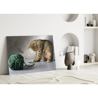Tabby cat playing with green yarn ball canvas wall art