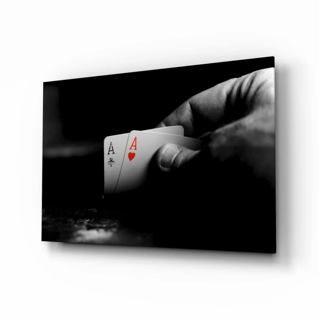 Black-and-white canvas wall art of hand holding ace of spades and red heart ace