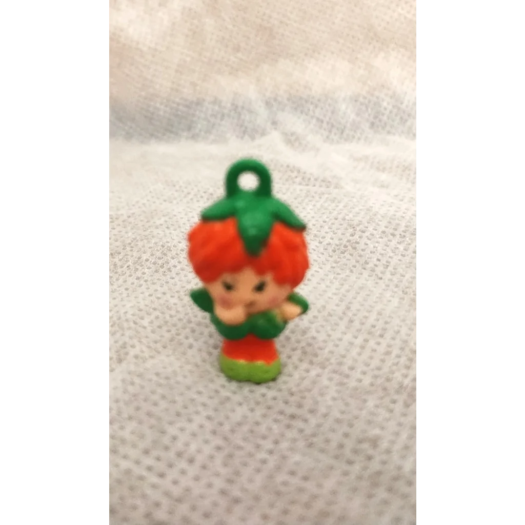 Cute poison ivy strawberry charm with green leaves and red plastic body