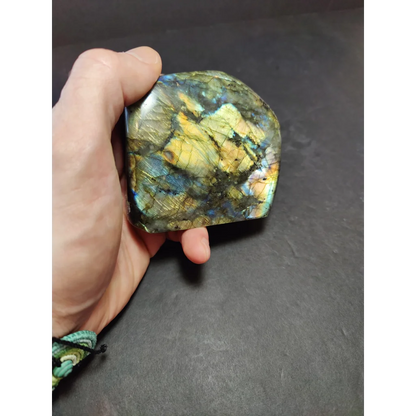 Polished labradorite free form sculpture with vibrant blue green and gold iridescent surface from labradorite free form