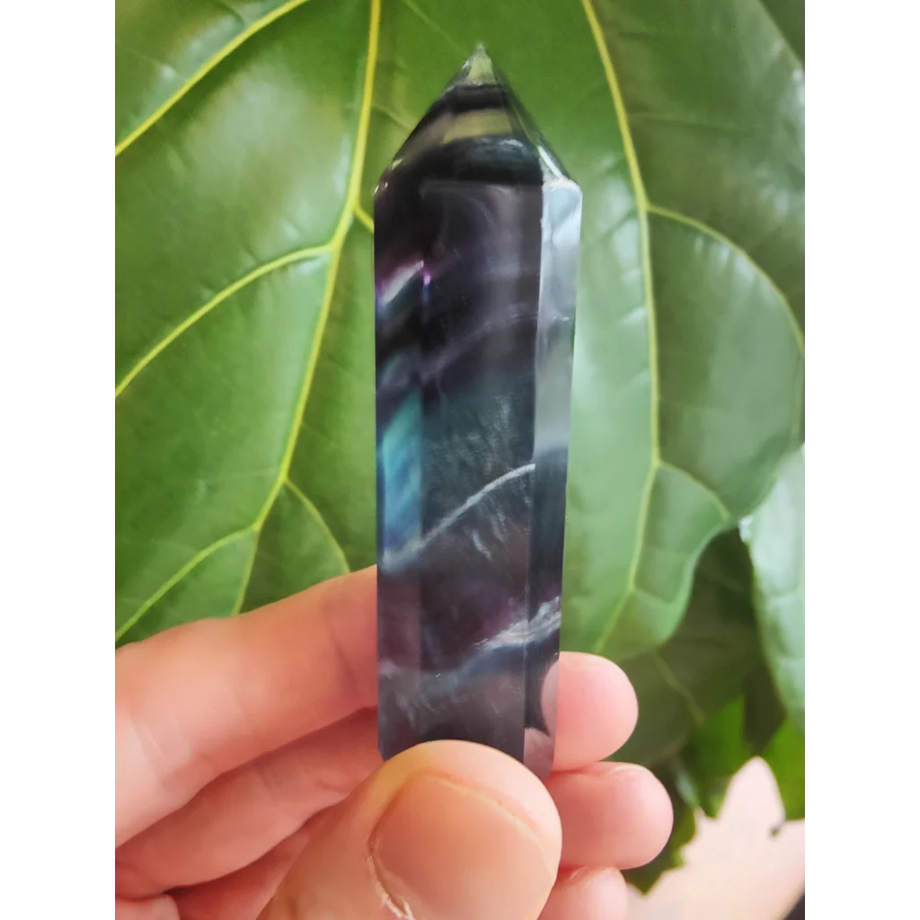 Polished multi-color fluorite tower 3 inch with dark purple crystal point and swirling blue and white patterns
