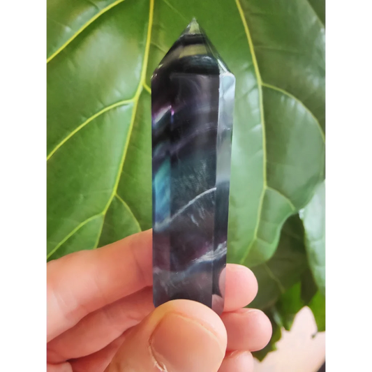 Polished multi-color fluorite tower 3 inch with dark purple crystal point and swirling blue and white patterns