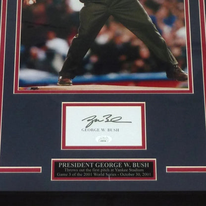 Signed framed 11x14 photo of President George W. Bush throwing first pitch with autograph