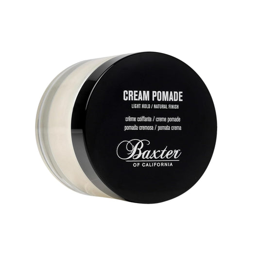Baxter of California Cream Pomade jar displayed at three-quarter angle with black lid and clear container showing cream-colored product inside.