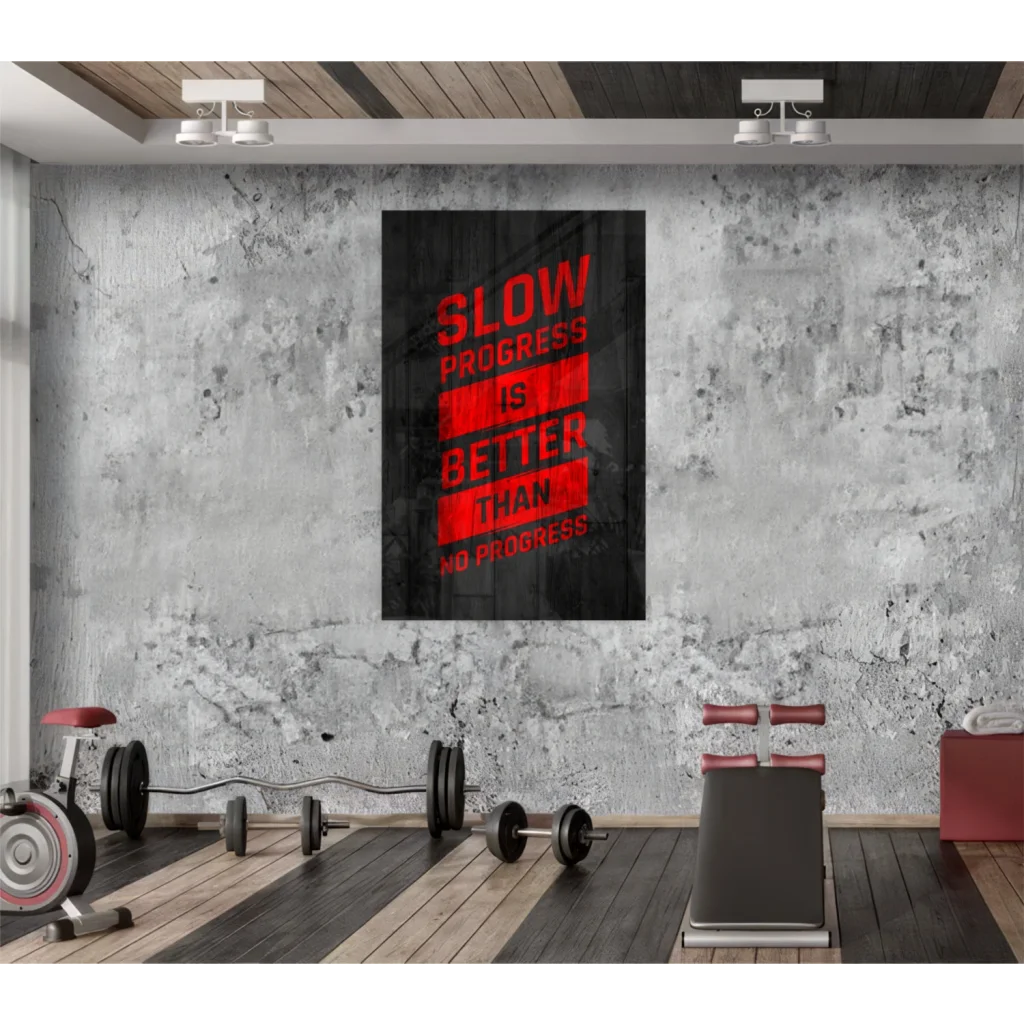 Black canvas motivational wall art with bold red text slow progress is better than no progress on distressed concrete wall