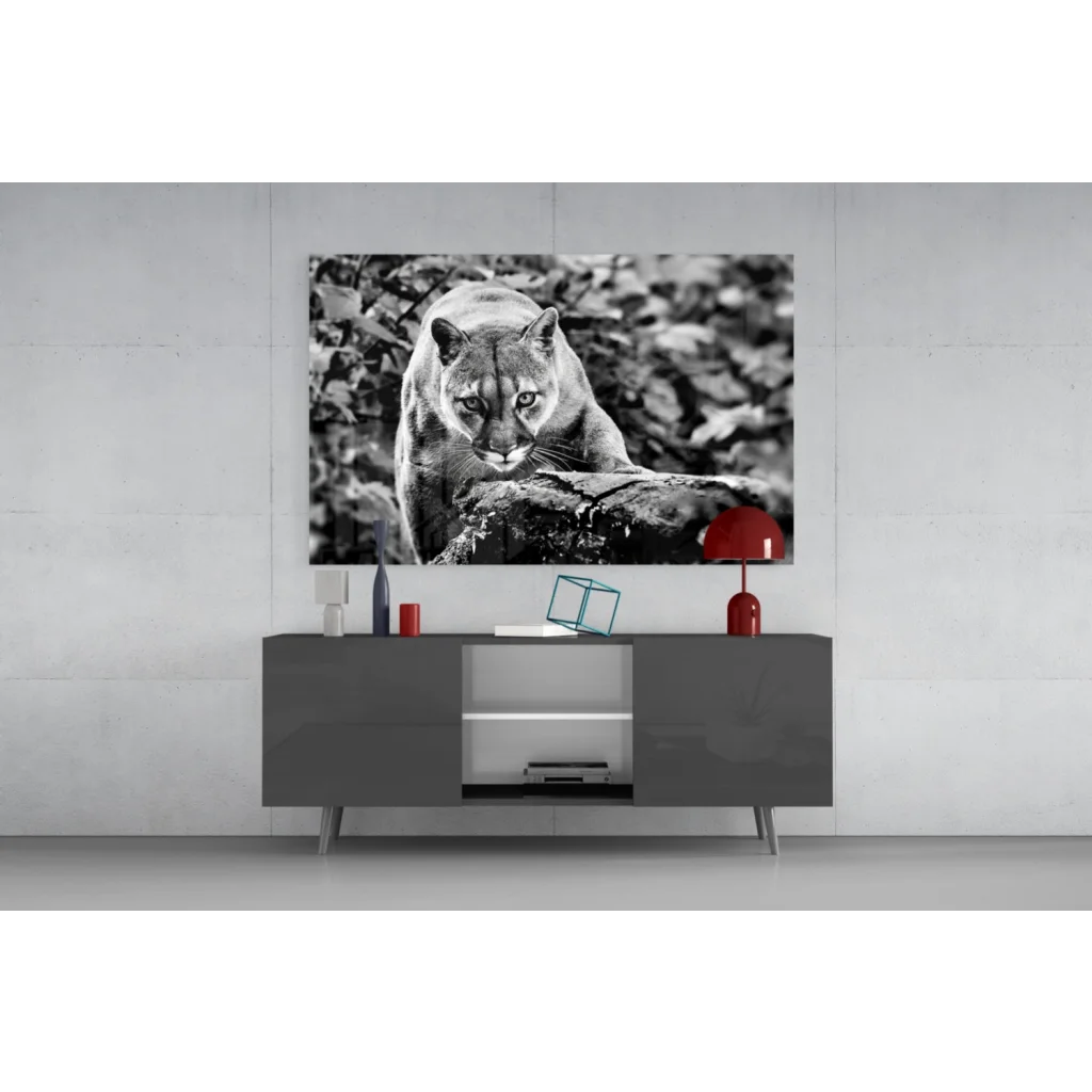 Black-and-white cougar on tree branch glass wall art