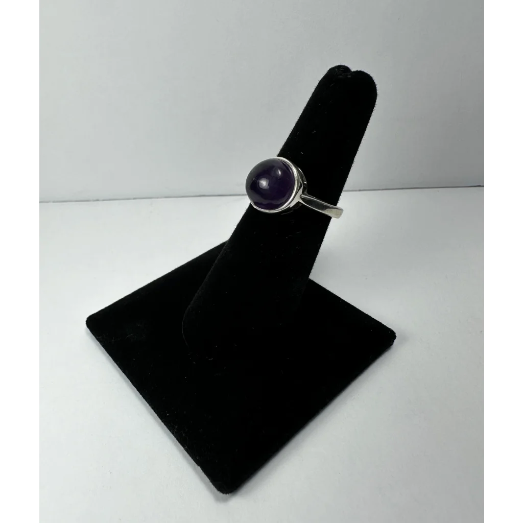 Sleek silver amethyst ring with minimalist band and purple gem