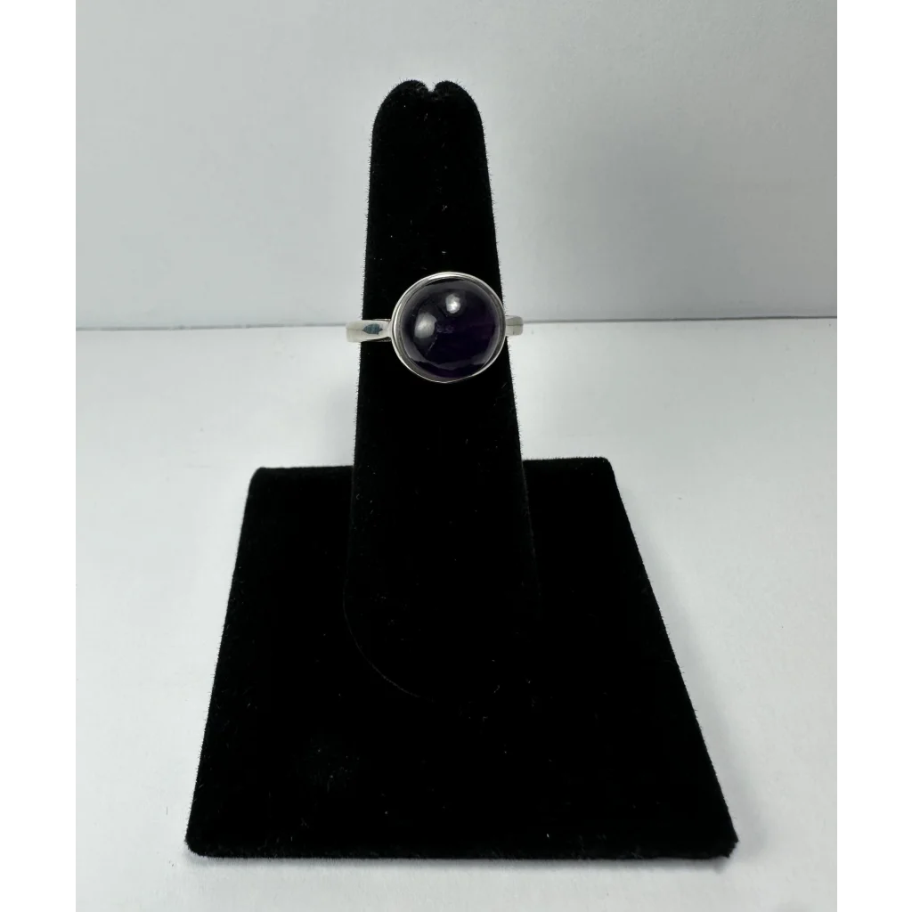 Simple sterling silver amethyst ring with round purple gem in minimalist bezel