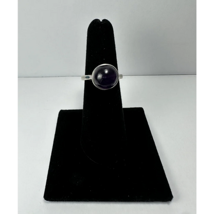 Simple sterling silver amethyst ring with round purple gem in minimalist bezel