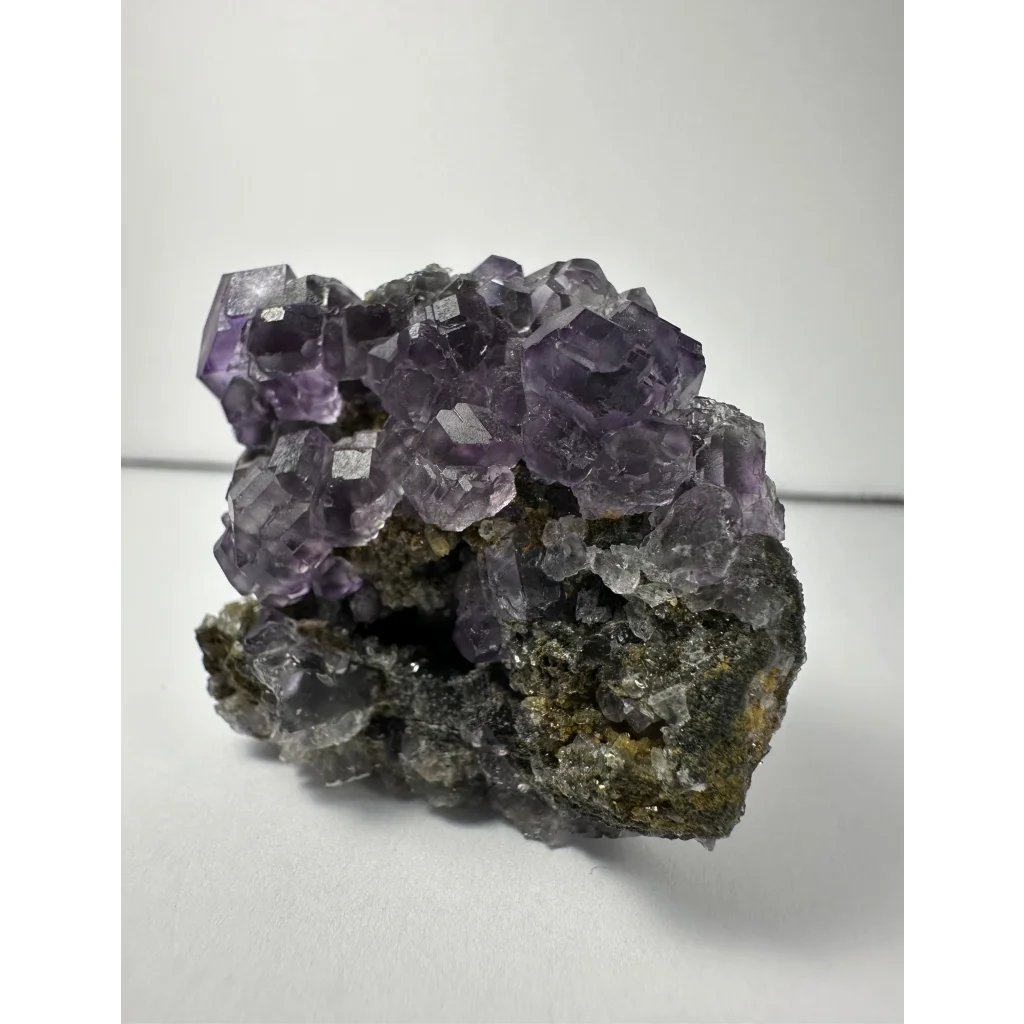 Vibrant purple dodecahedral fluorite crystal cluster from China