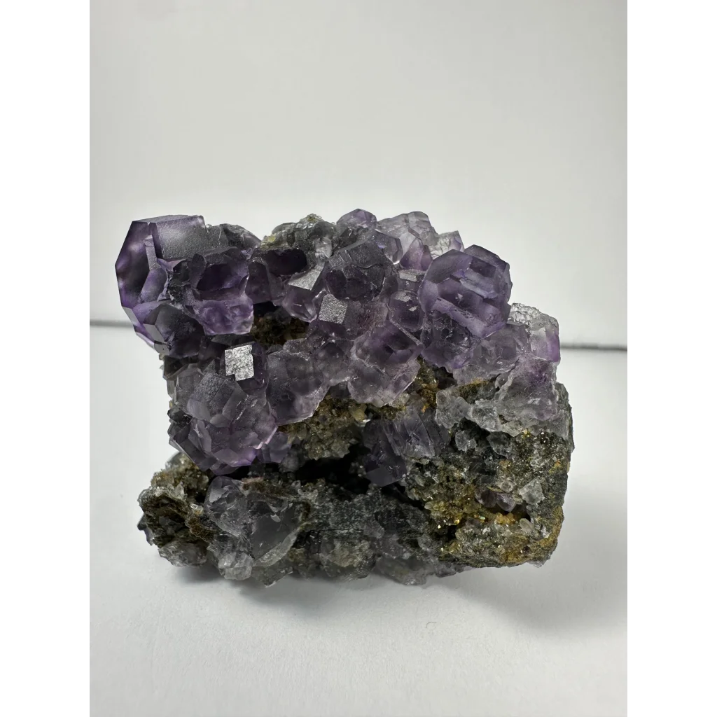 Vibrant purple dodecahedral fluorite crystal cluster from China