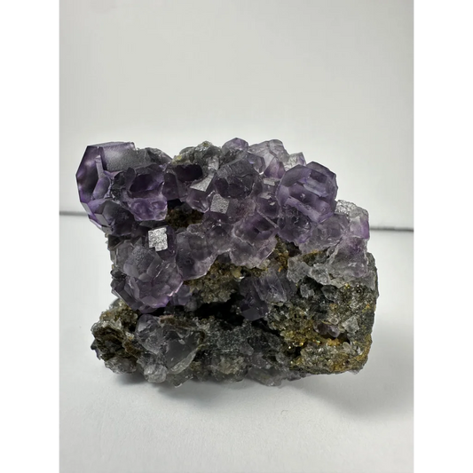 Vibrant purple dodecahedral fluorite crystal cluster from China