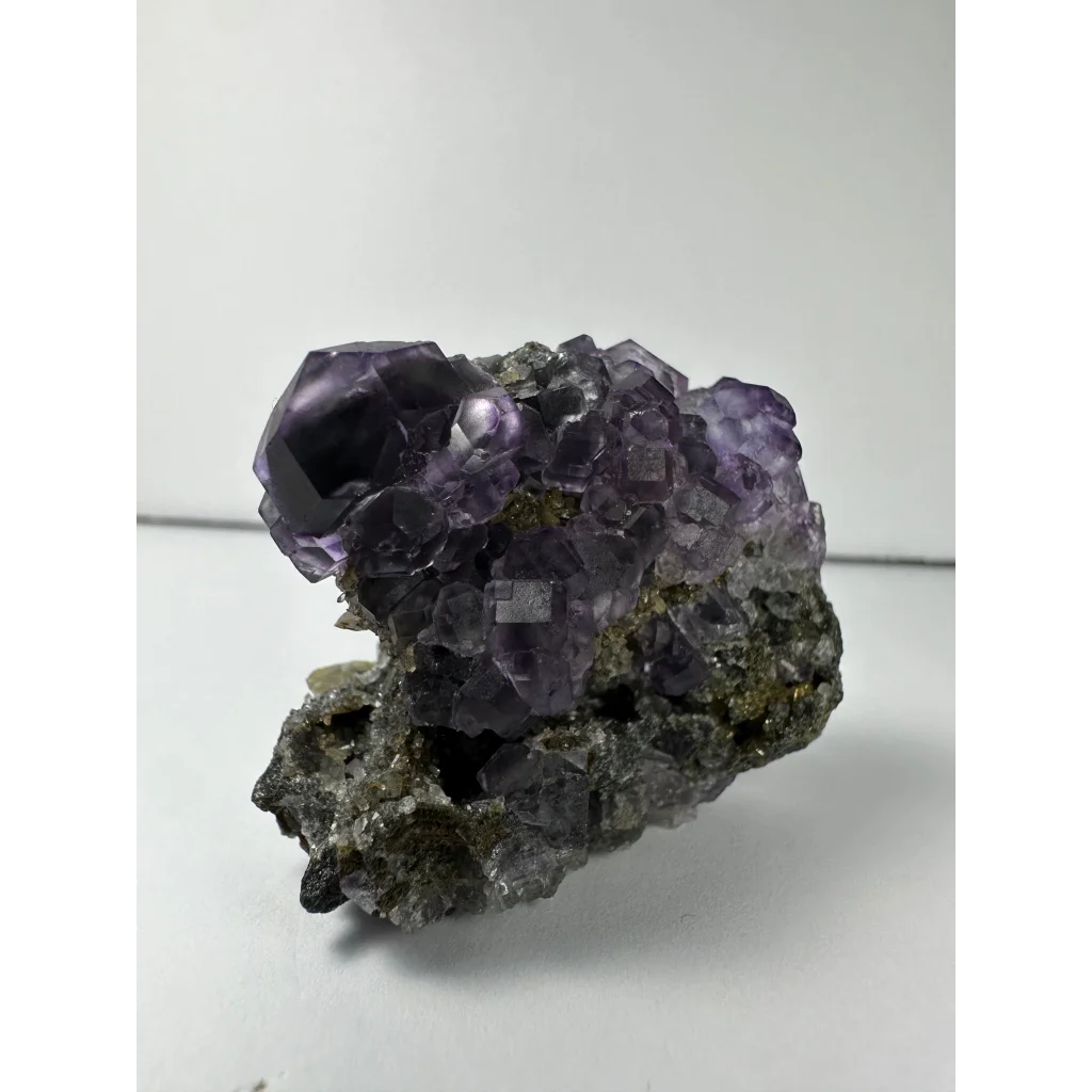 Vibrant purple dodecahedral fluorite crystal cluster from China