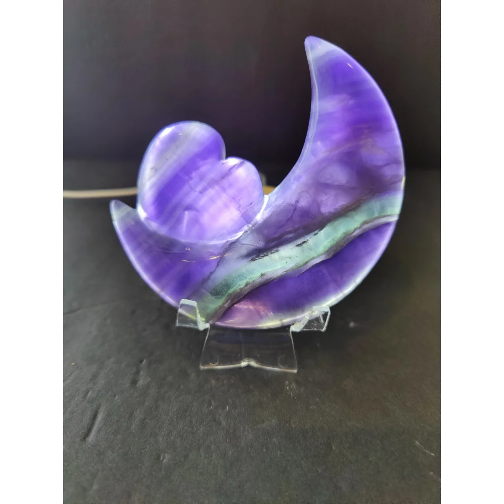 Purple fluorite half-moon and heart sculpture in translucent purple and teal on a 5 inch metal stand