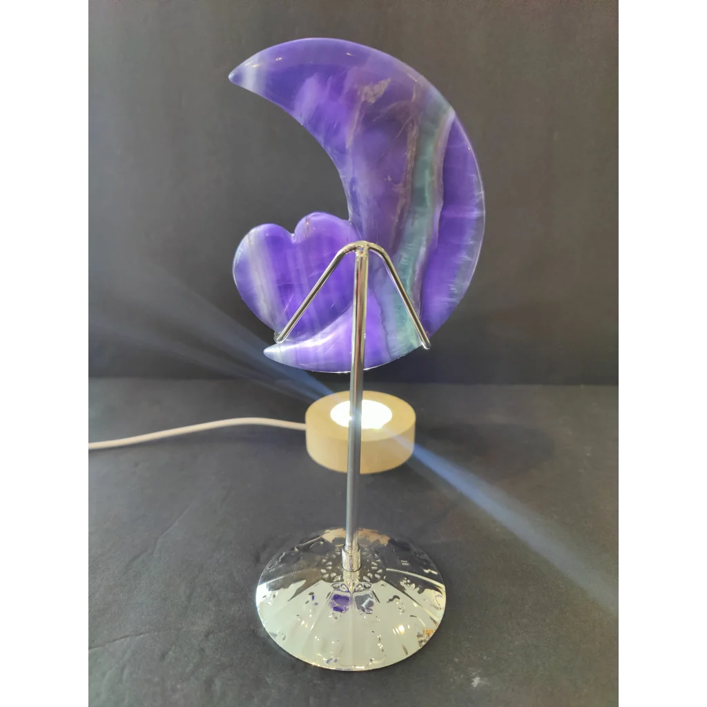Purple fluorite half-moon and heart sculpture with a purple and teal marbled lamp on a 5 inch metal stand