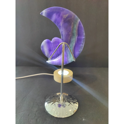 Purple fluorite half-moon and heart sculpture with a purple and teal marbled lamp on a 5 inch metal stand