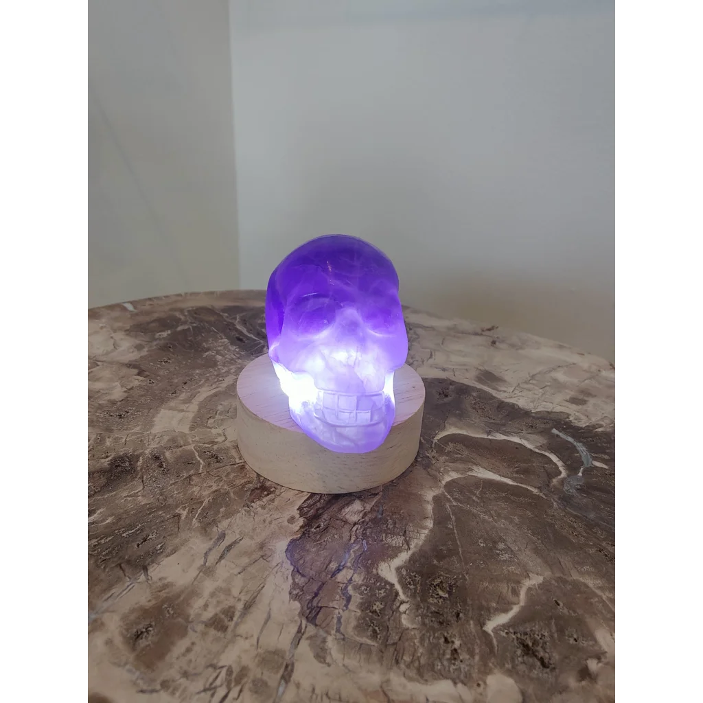 Purple fluorite skull sculpture led lamp with translucent glowing finish in vibrant purple fluorite skull design