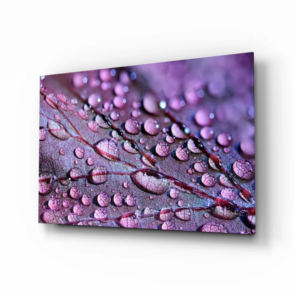 Purple-toned glass wall art of dewdrops on veined leaf