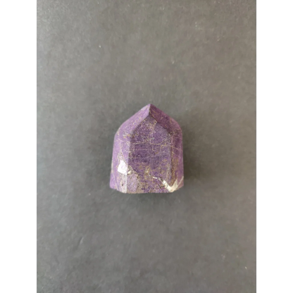 Faceted purple amethyst crystal with golden inclusions in Purpurite Lapidary