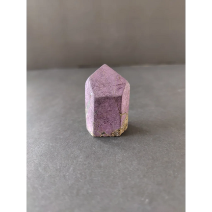 Purpurite Lapidary: faceted purple crystal with gold-tipped base
