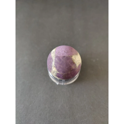 Polished purpurite lapidary sphere in purple and gold with natural banding