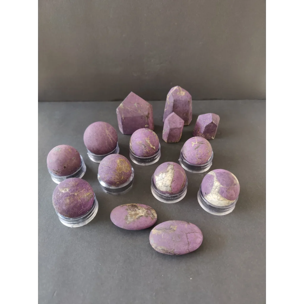 Purple amethyst geodes with golden inclusions on clear stands, Purpurite Lapidary