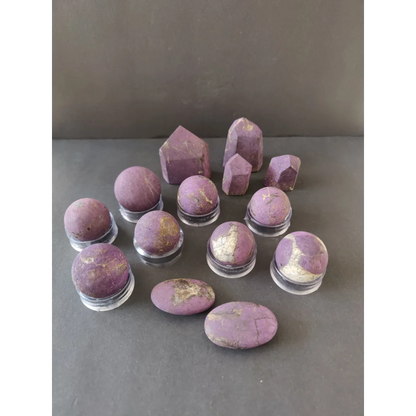 Purple amethyst geodes with golden inclusions on clear stands, Purpurite Lapidary
