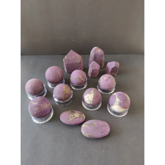 Purple amethyst geodes with golden inclusions on clear stands, Purpurite Lapidary
