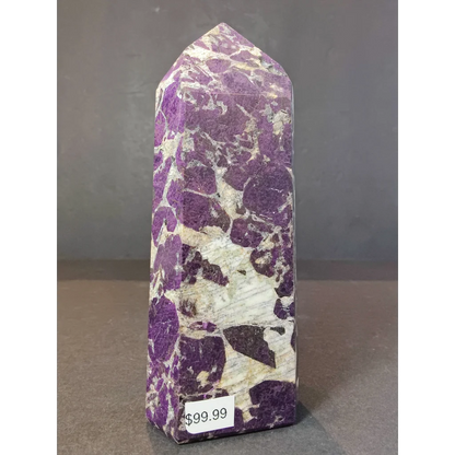 Purpurite polished obelisk tower sculpture with purple and white marbled crystal and pointed top showcasing mineral patterns