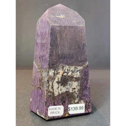 Polished purple amethyst purpurite polished obelisk tower sculpture with faceted pyramid top and natural mineral inclusions