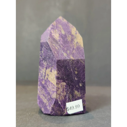 Purpurite polished obelisk tower sculpture in purple and gold speckled amethyst crystal with a pointed upright top