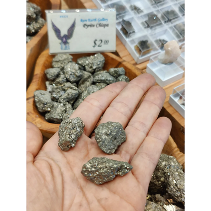 Hand holding glittering pyrite chispa chips