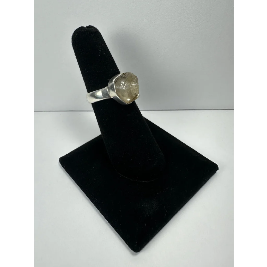 Silver quartz ring with raw faceted stone on sleek metal band