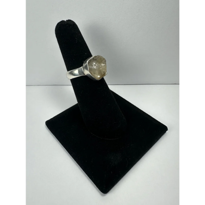 Silver quartz ring with raw faceted stone on sleek metal band