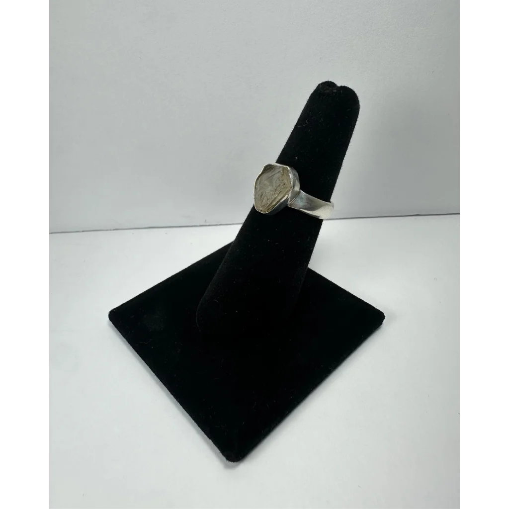 Silver quartz ring with hexagonal engraved stone on polished band