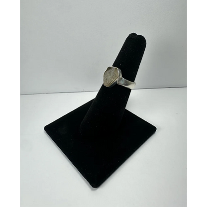 Silver quartz ring with hexagonal engraved stone on polished band