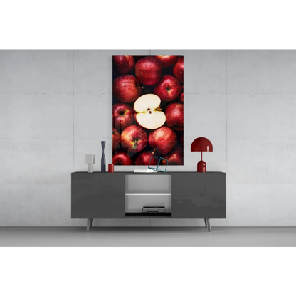 Juicy red apple glass wall art with sliced apple on canvas above gray console