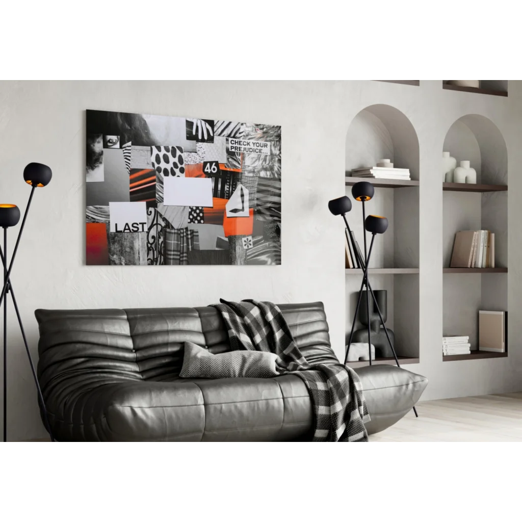 Black leather sofa with plaid throw on Question Your Prejudice glass wall art