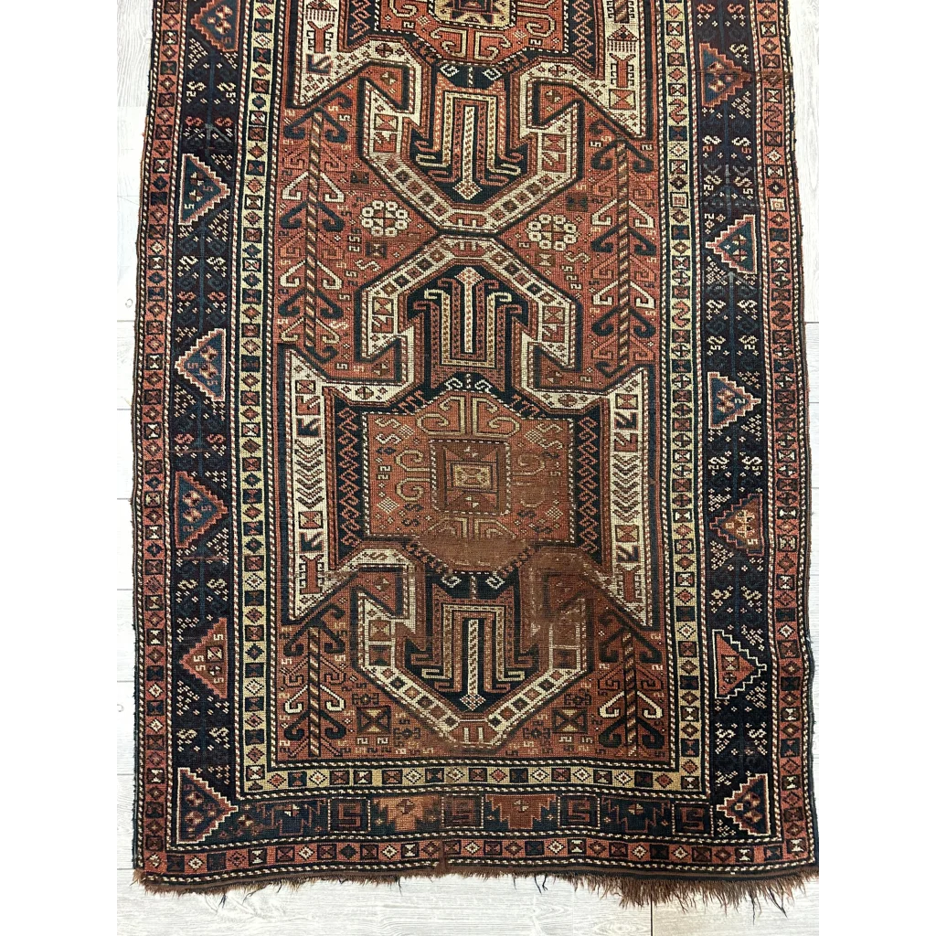 Antique Kazak Sewan runner 1875, bold geometric patterns in rust cream and brown, pre-loved patina