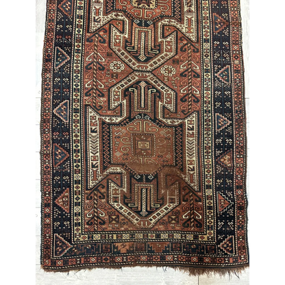 Antique Kazak Sewan runner 1875, bold geometric patterns in rust cream and brown, pre-loved patina