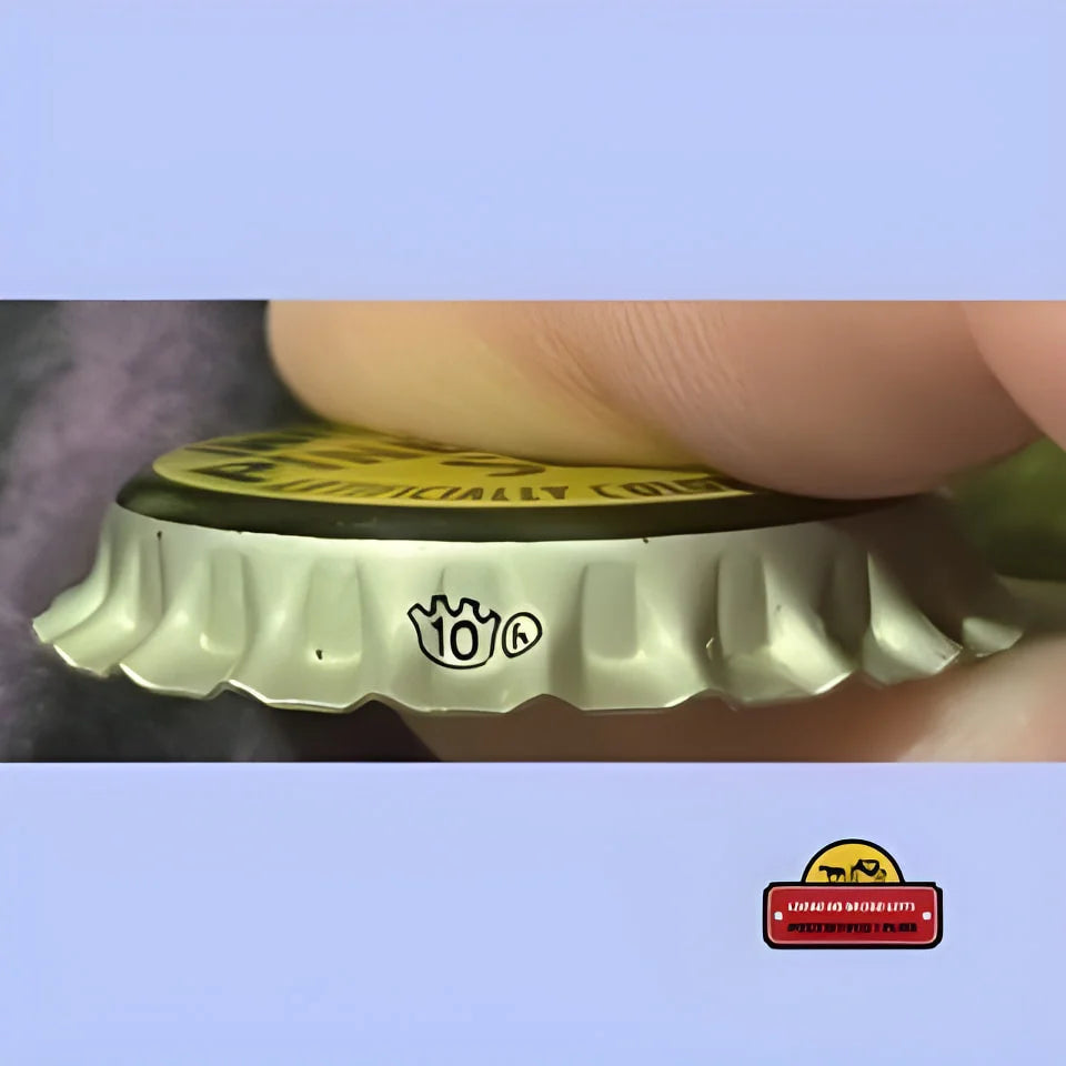 Finger holding a ruffled edge bottle cap from a Rare 1950s Antique Vintage Pineapple Soda