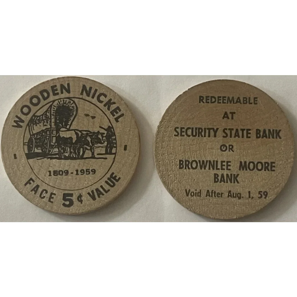 Two 1950s wooden nickel tokens featuring a covered wagon design and redemption details