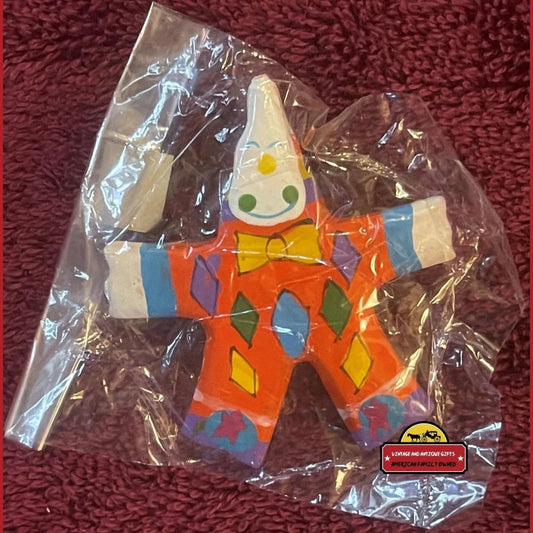 Colorful 1960s handmade wood clown toy figure in a plastic wrapper for circus fun