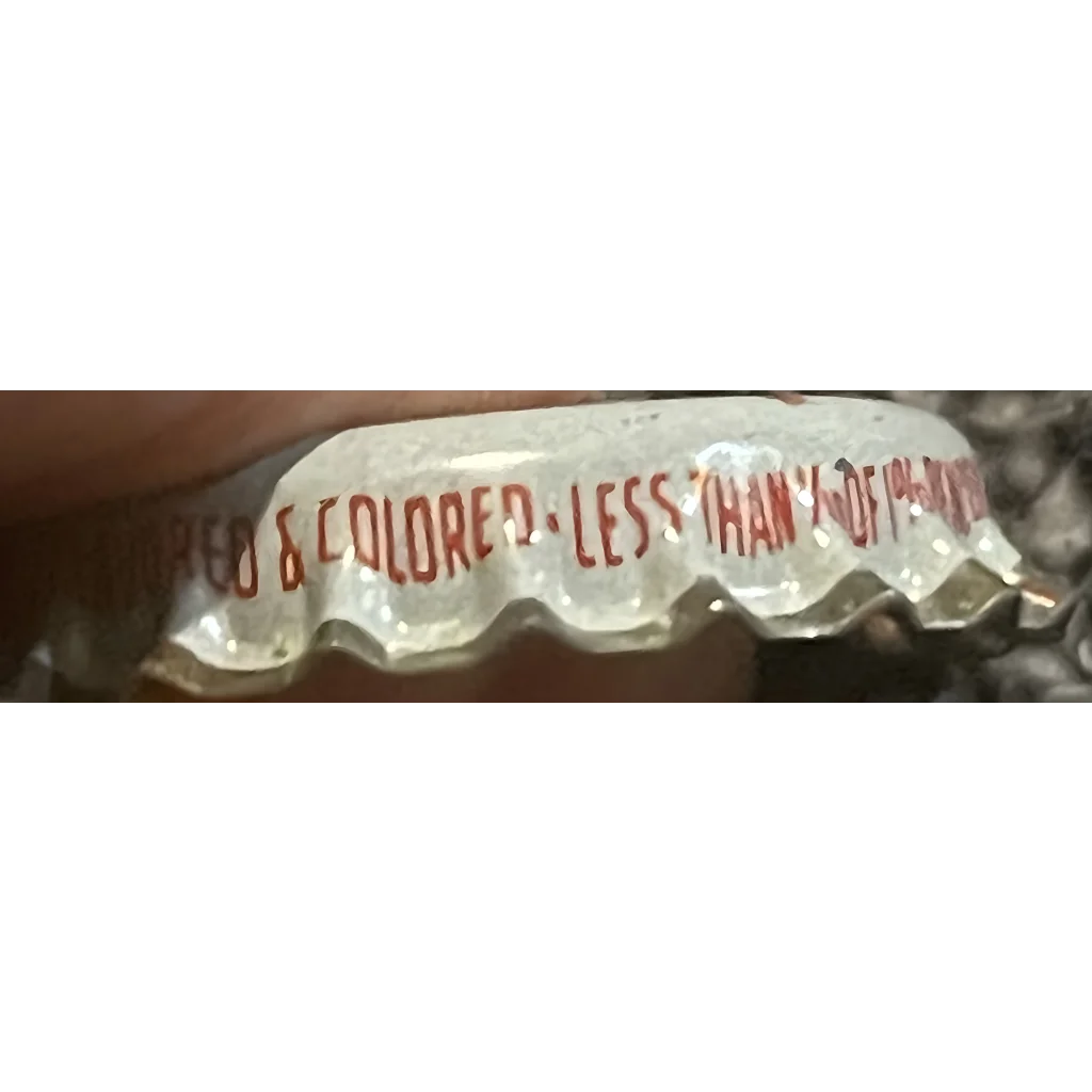 Bottle cap featuring red text COLORED - LESS THAN 1/10 OF 1% from Rare 1960s Red Eye Root Beer