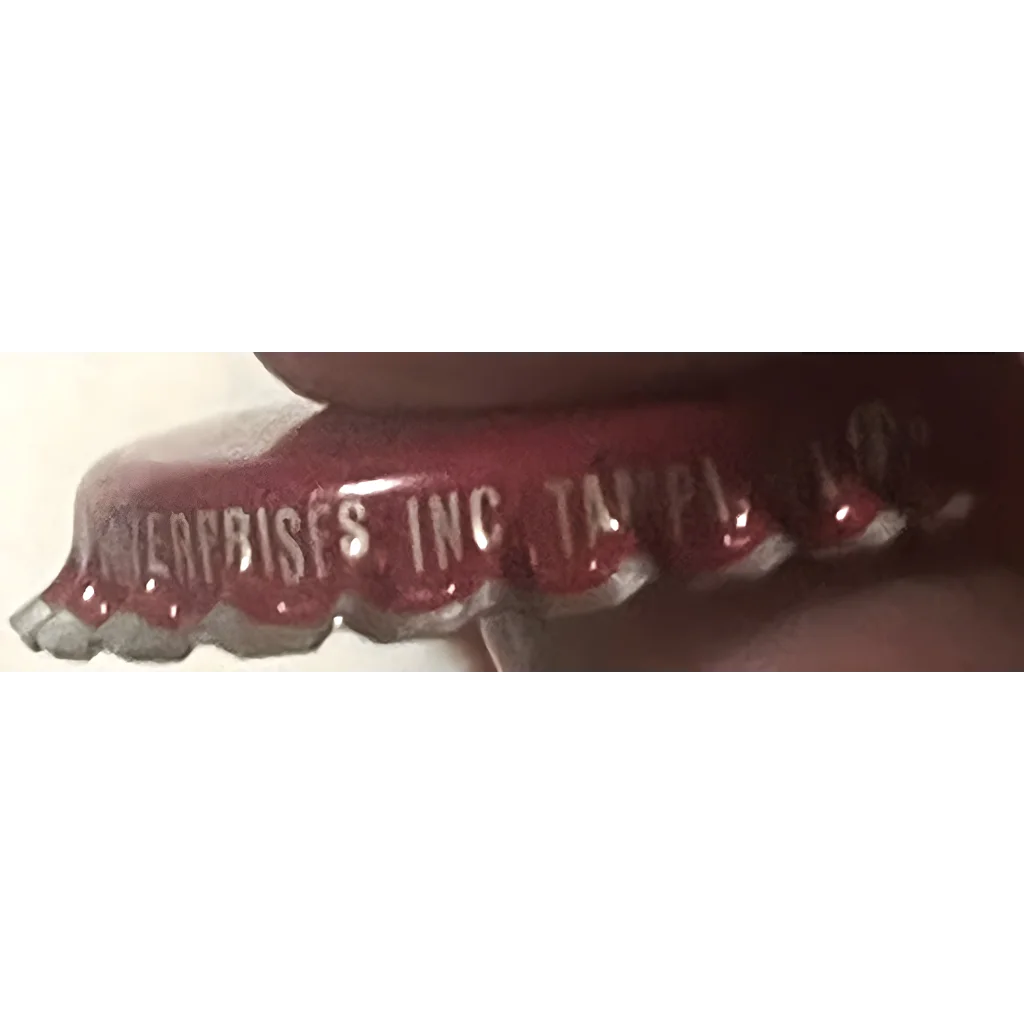 Set of dentures with engraved text next to a Rare 1970s Whistle Strawberry Soda bottle cap