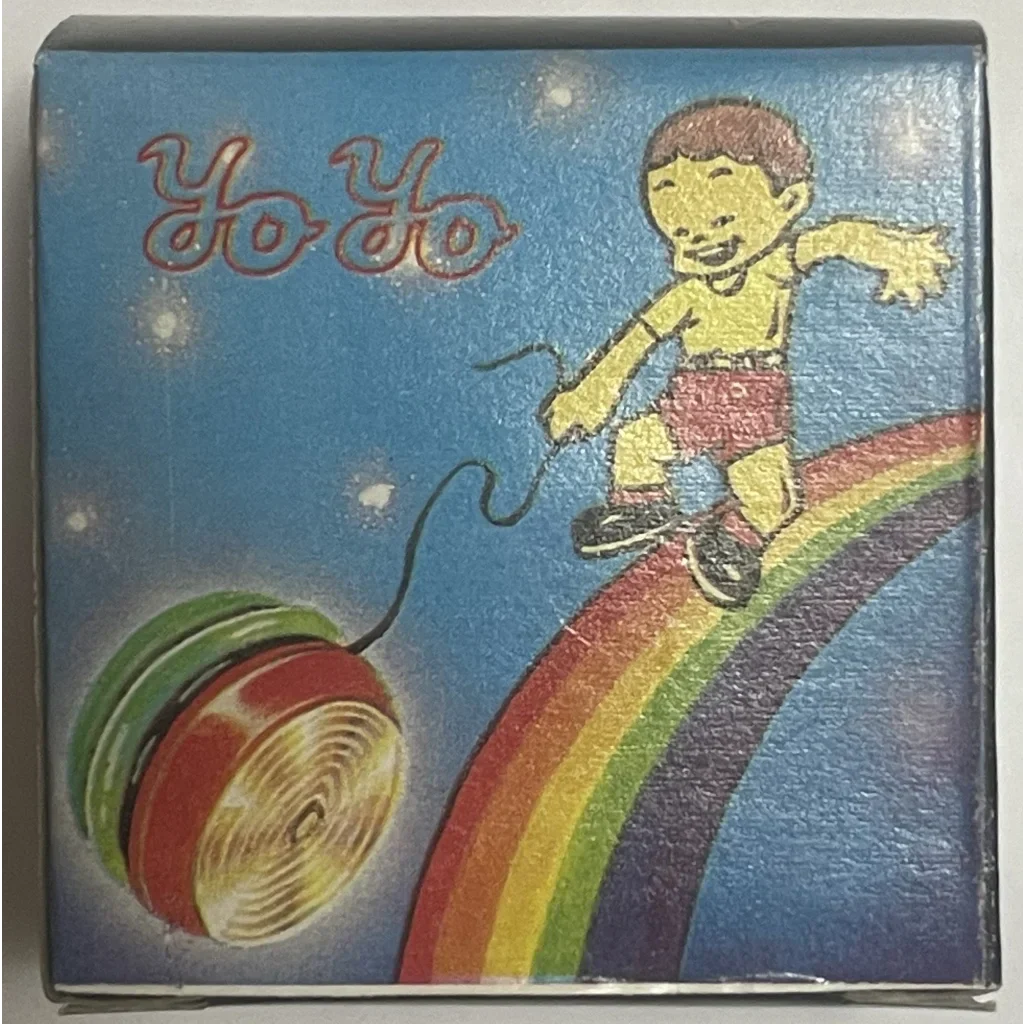 Vintage yo-yo toy packaging with a cartoon kid on a rainbow, 1980s vintage light design