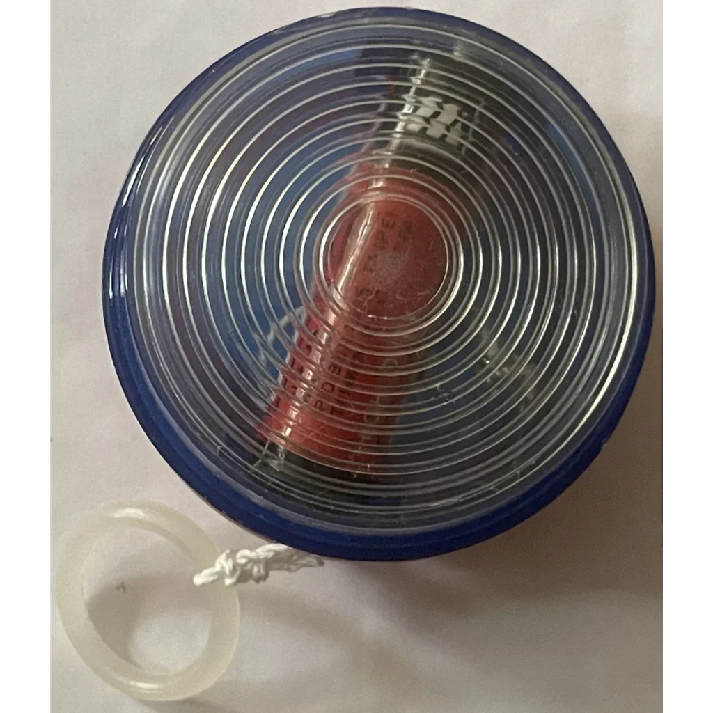 Circular 1980s vintage yo-yo with concentric rings and blue rim for a fun light-up toy