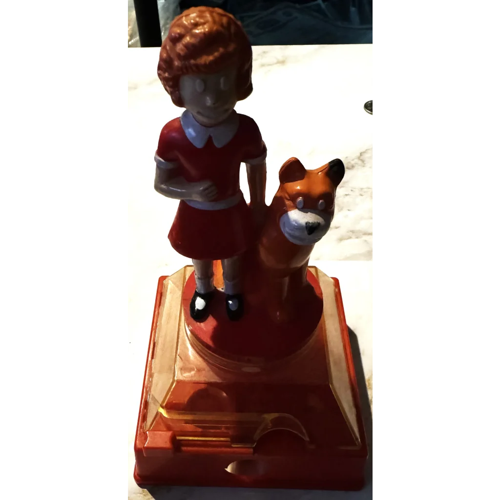 Vintage Annie Coin Bank figurine of a girl in a red dress with a dog on a base