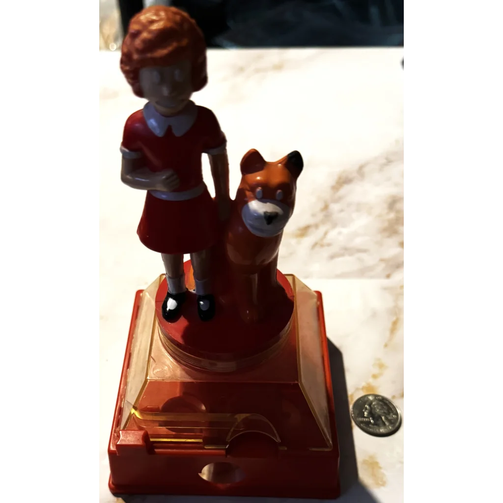 Decorative child figurine in red dress with fox on brown base for 1981 Annie Coin Bank