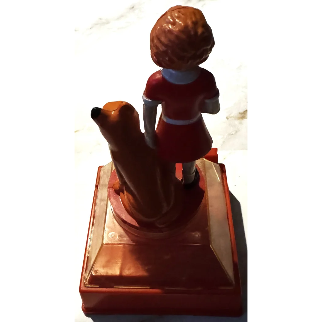 Red plastic coin bank with Annie in a dress and dog, perfect for collectors